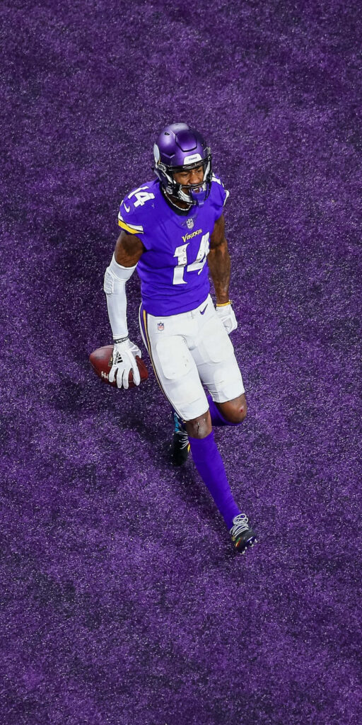 Vibrant Football Player Wallpaper on Bold Purple Field Background