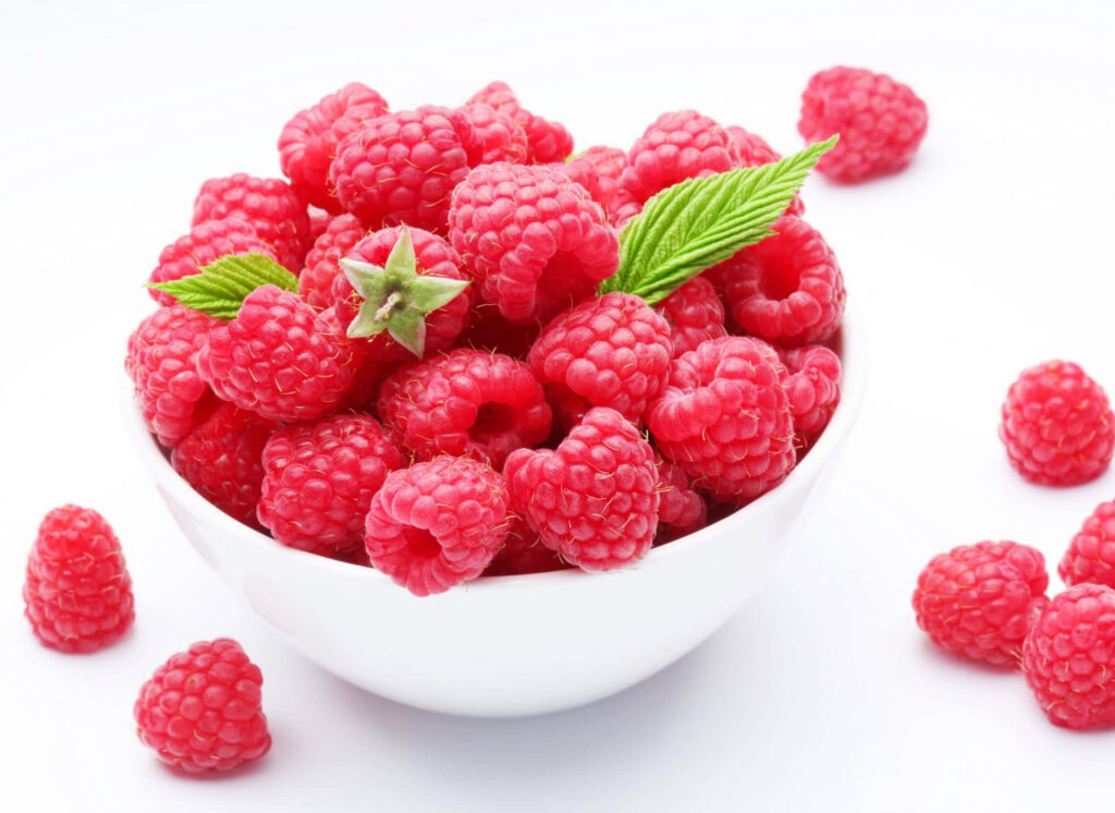 Vibrant Raspberry Bowl Wallpaper Against Clean White Background
