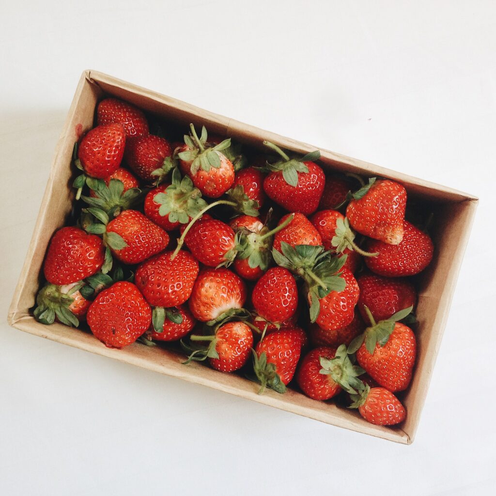 Vibrant Wallpaper: Fresh Red Strawberries in Cardboard Box Background
