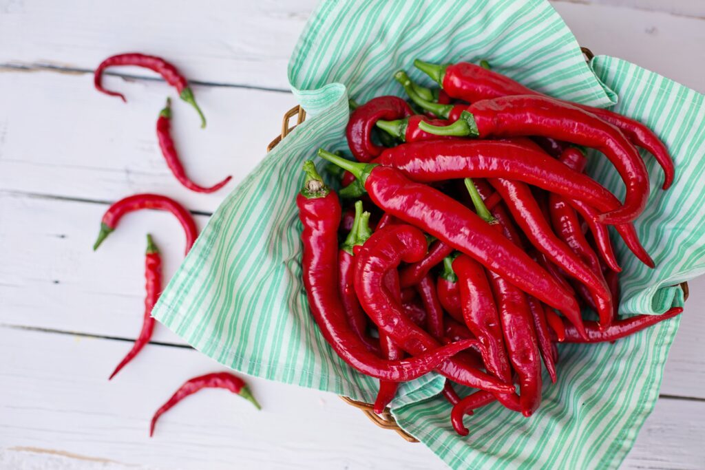 Vibrant Chili Peppers Wallpaper on Striped Cloth & Rustic Wood