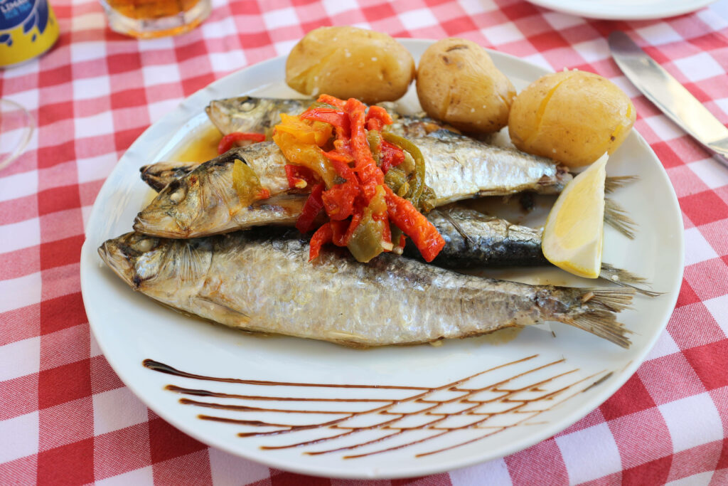 Vibrant Wallpaper: Grilled Sardines with Peppers on Checkered Table