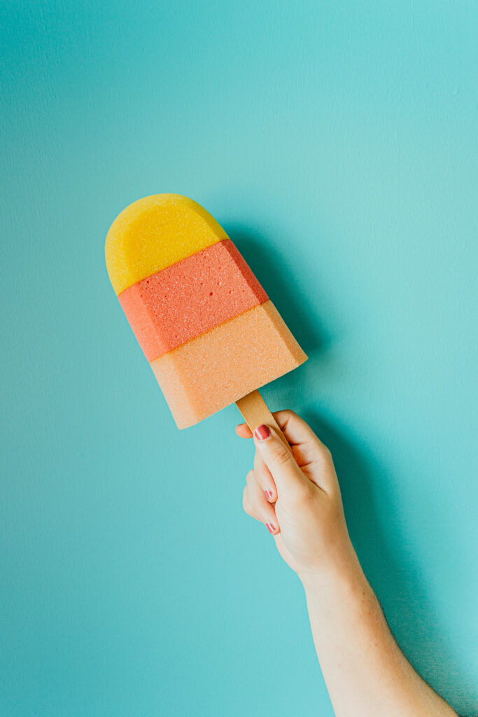 Colorful Ice Pop & Hand Wallpaper on Pastel Turquoise Background