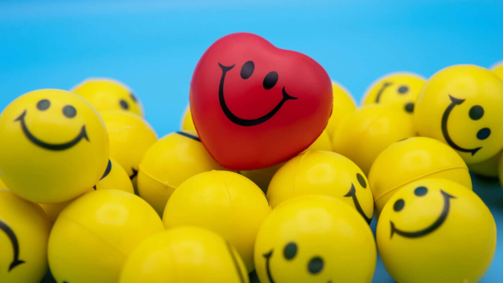 Bright Red Heart & Yellow Smiley Faces Wallpaper on Blue Background