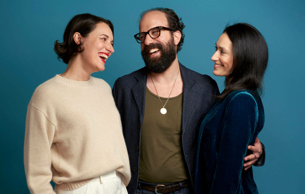 Joyful Moment Wallpaper: Three Friends against a Blue Background