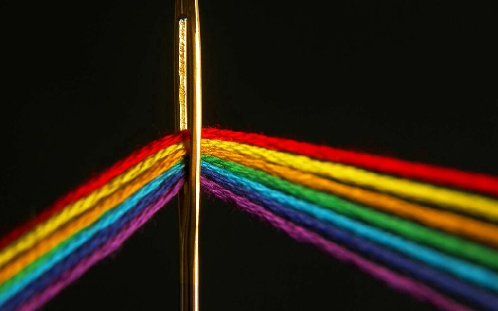 Vibrant Needle and Colorful Threads Wallpaper Background