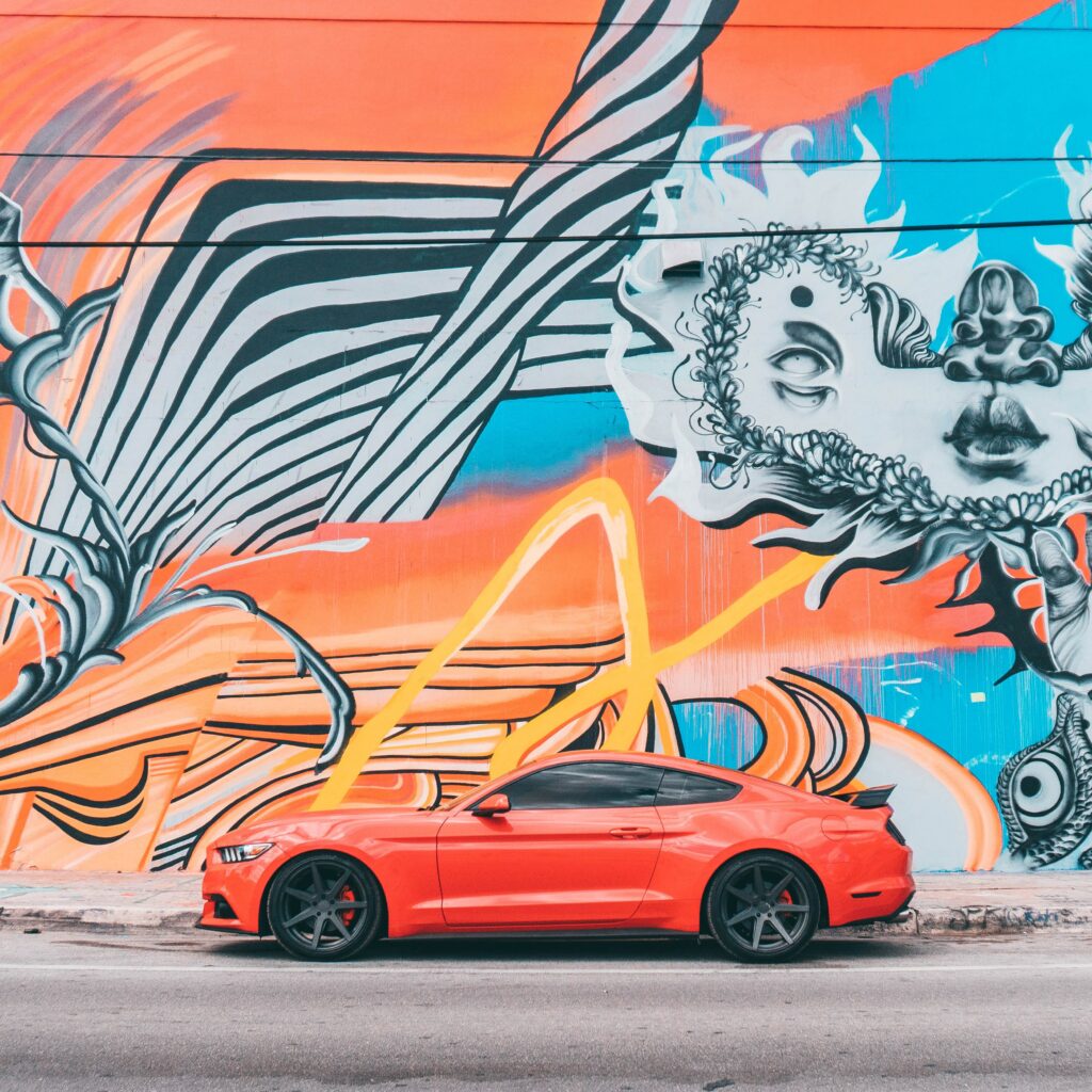 Vibrant Graffiti Wall with Sleek Red Sports Car - Urban Wallpaper