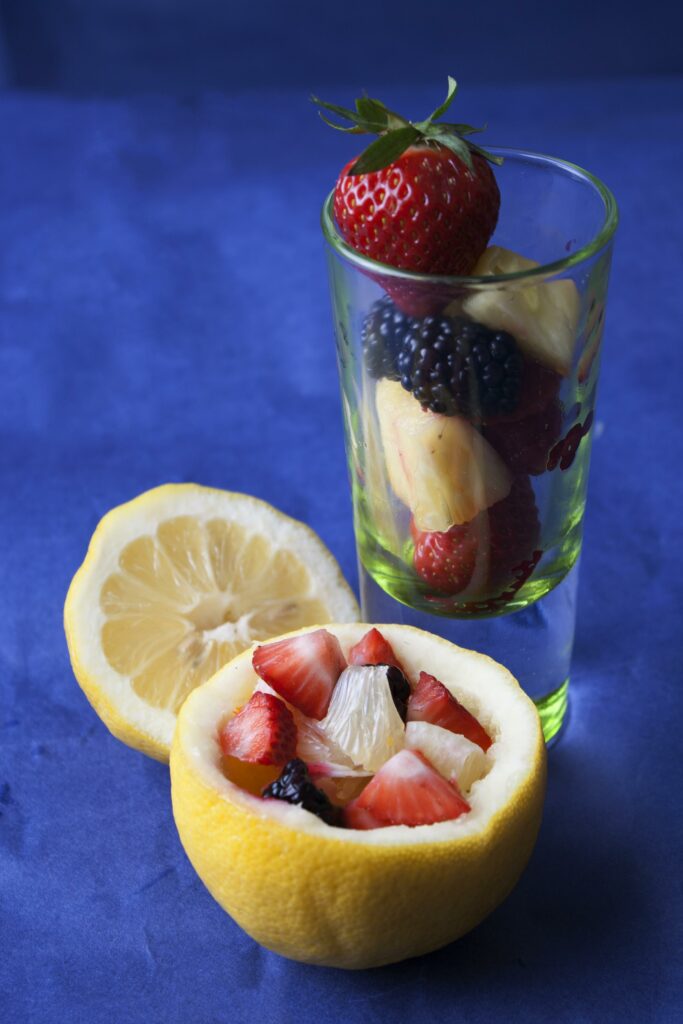 Colorful Berry & Pineapple Dessert Wallpaper on Blue Background