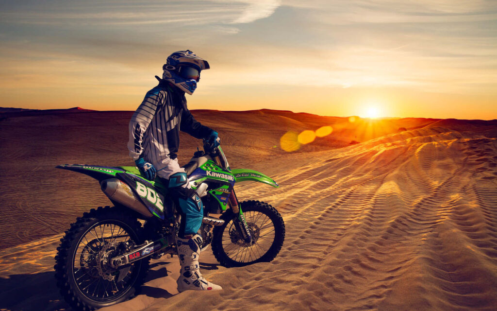 Vibrant Dirt Bike Rider Wallpaper: Neon Green Sunset Adventure
