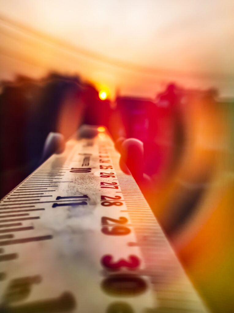 Vibrant Wallpaper: Close-Up Ruler with Glowing Sun Background