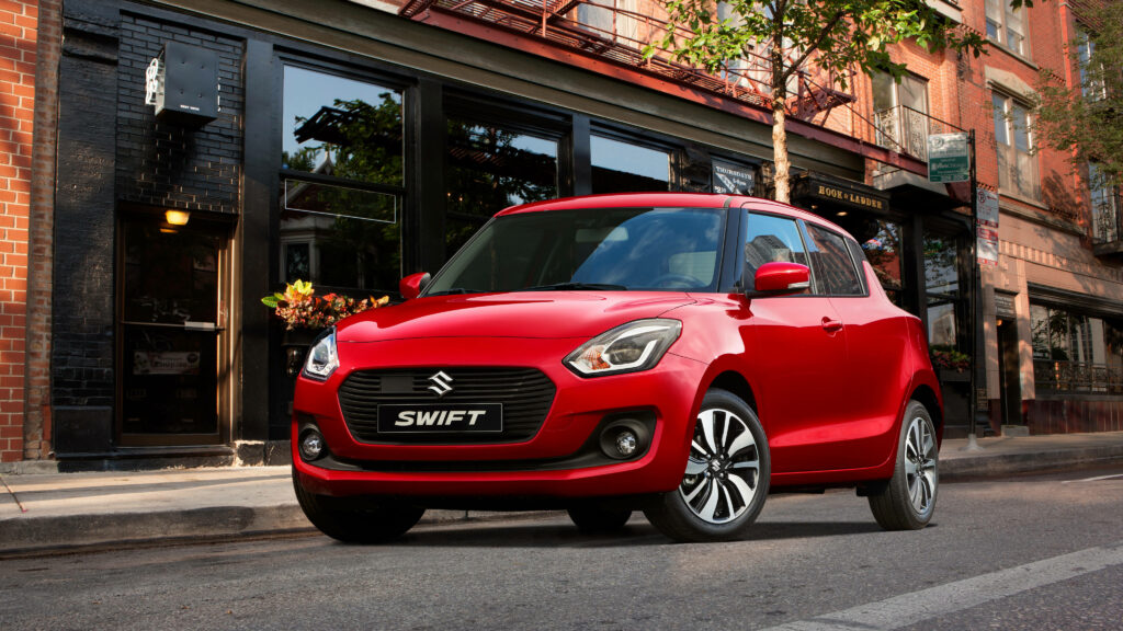 “Vibrant Wallpaper: Sleek Red 2017 Suzuki Swift in Urban Setting”