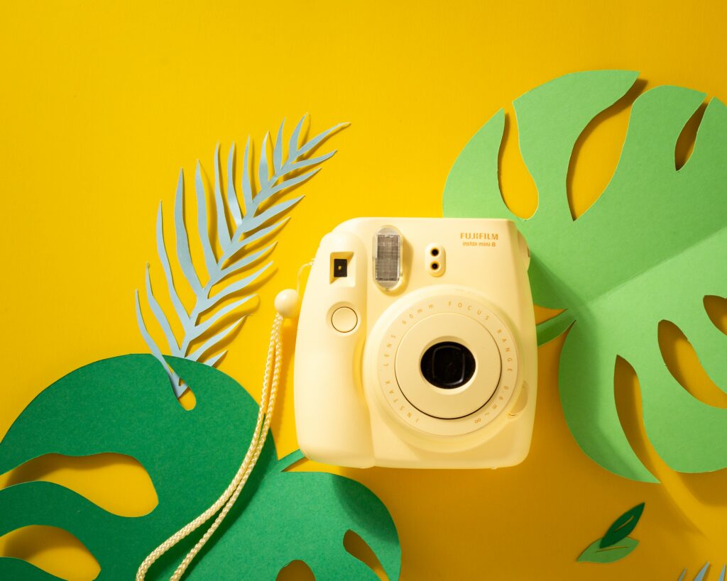 Vibrant Polaroid Camera Wallpaper with Yellow and Green Accents
