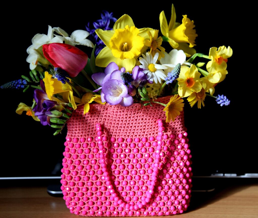 Vibrant Pink Bag with Spring Flowers on Dark Background Wallpaper
