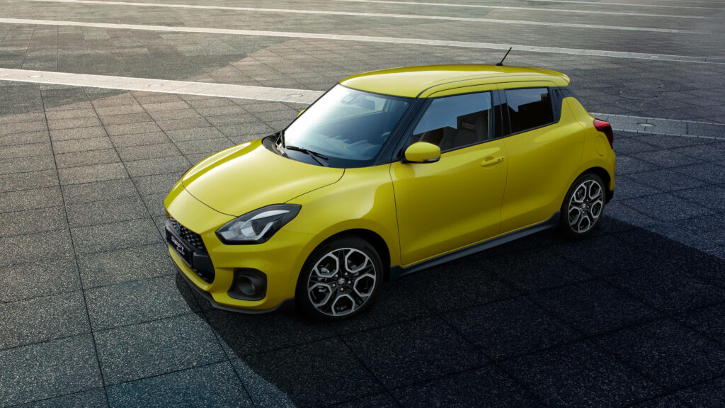 Yellow Suzuki Swift Sport Wallpaper on Modern Tiled Background