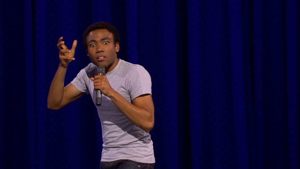 “Dynamic Donald Glover Stage Performance Wallpaper Background”