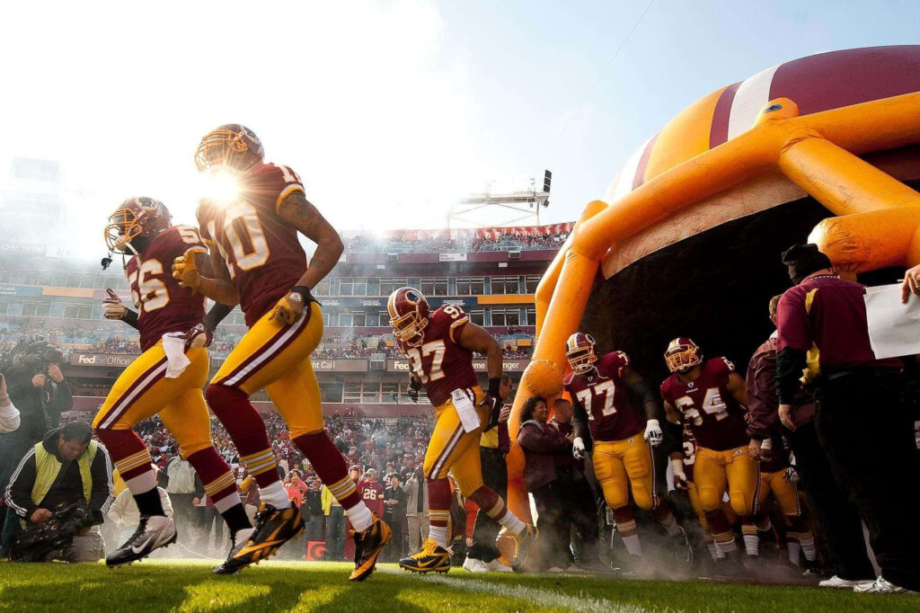 Vibrant Redskins Players Wallpaper: Team Spirit in a Packed Stadium