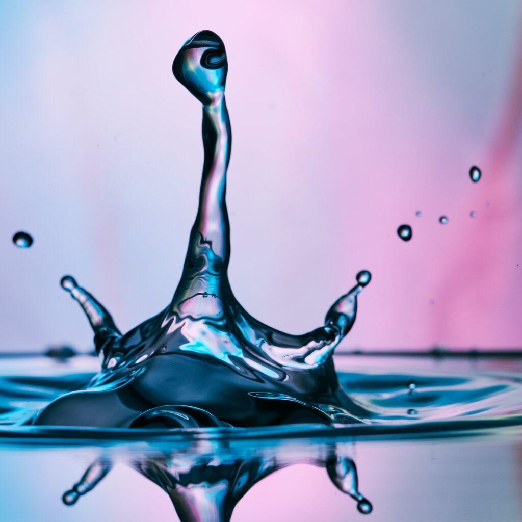 Vibrant Water Drop Splash Wallpaper on Colorful Gradient Background