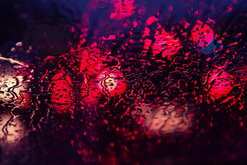 Vibrant Water Drop Wallpaper Background with Red and Purple Lights