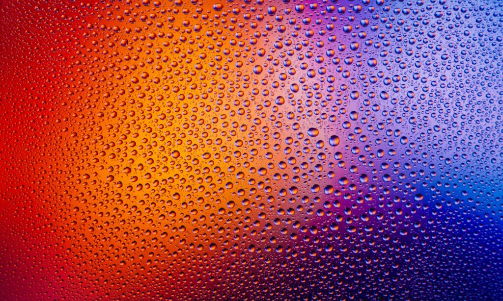 Vibrant Water Droplets on Gradient Background: Colorful Design Wallpaper