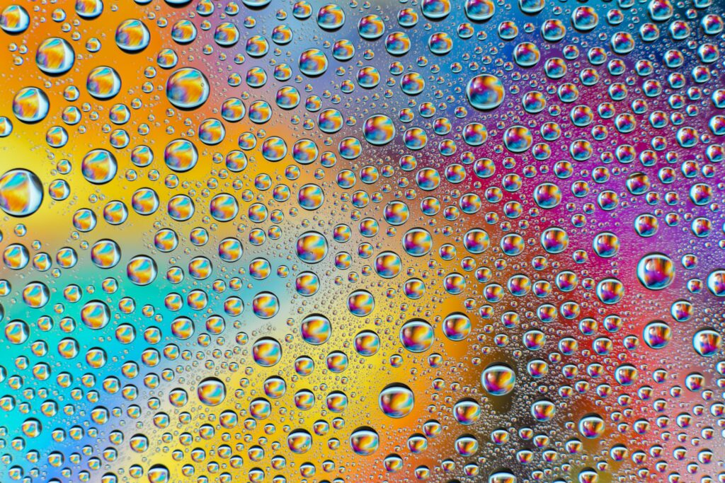 Vibrant Rainbow Gradient Wallpaper with Stunning Reflective Water Droplets