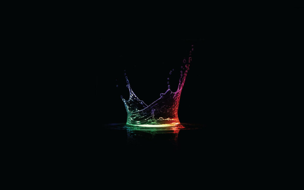 Vibrant Mid-Air Water Splash: Rainbow Colors on Dark Background Wallpaper