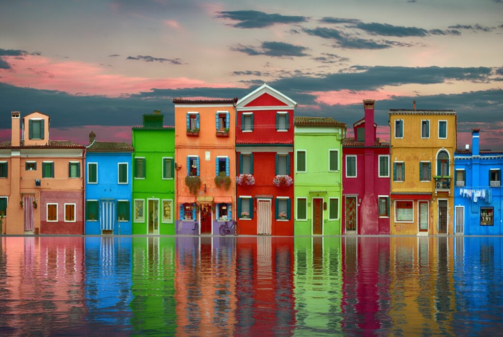 Colorful Houses by Serene Waterfront - Vibrant Wallpaper Background