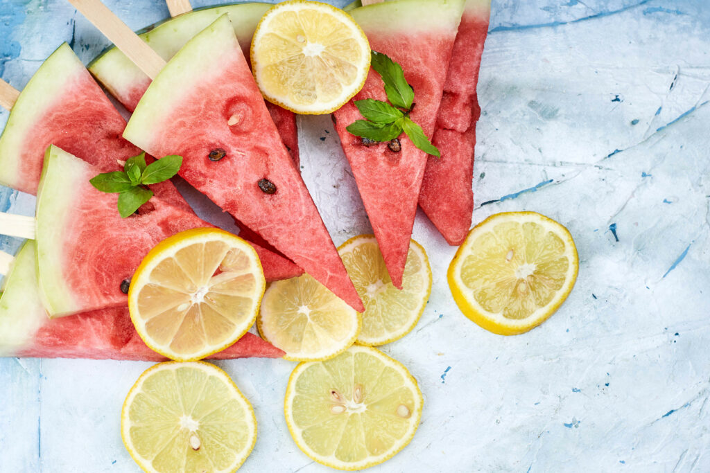 Vibrant Watermelon & Lemon Wallpaper on Textured Blue Background