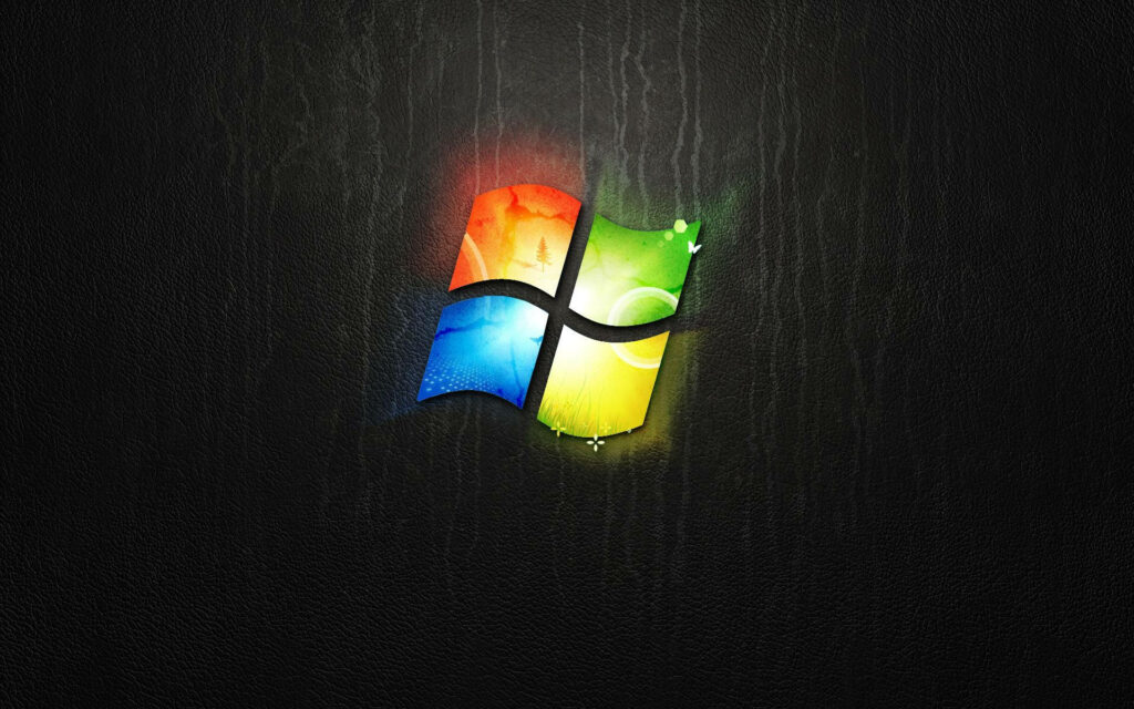 Vibrant Illumination: Windows 10 Logo Shines on a Stylish Black Textured Backdrop Wallpaper
