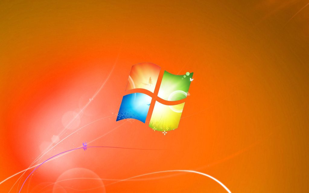 Windows Orange Theme wallpaper with classic logo on vibrant abstract gradient and light trails