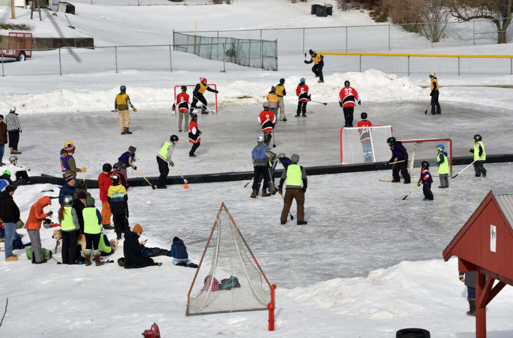 Colorful Broomball Match: Lively Winter Scene Wallpaper Background
