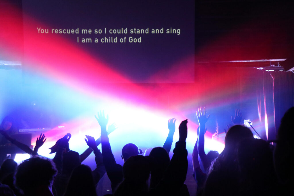 Vibrant Worship Scene Wallpaper: Faith, Redemption & Colorful Lights