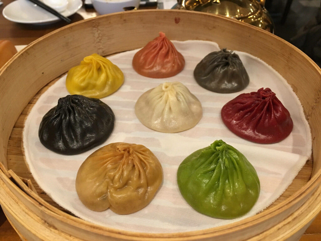 Vibrant Xiaolongbao Wallpaper: Colorful Dumplings on White Cloth