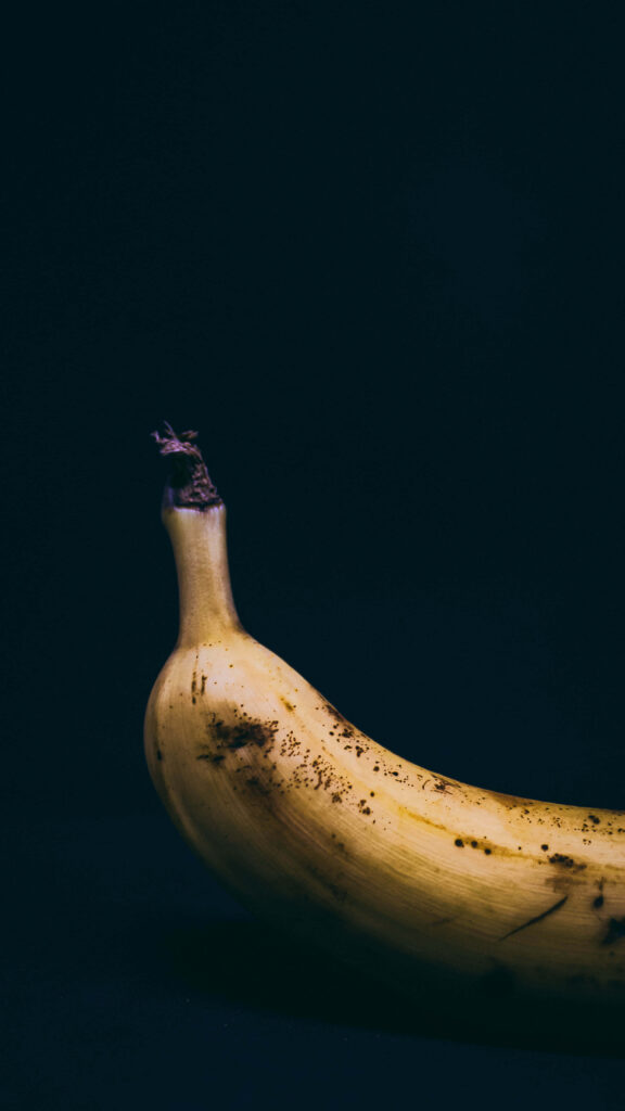 Ripe yellow banana on black background vibrant fruit detail fresh tropical produce wallpaper