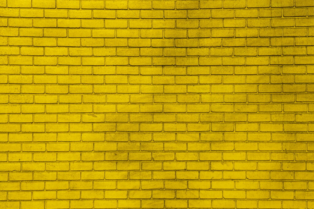 Vibrant Yellow Brick Wall: Captivating Texture in 5K Wallpaper Background