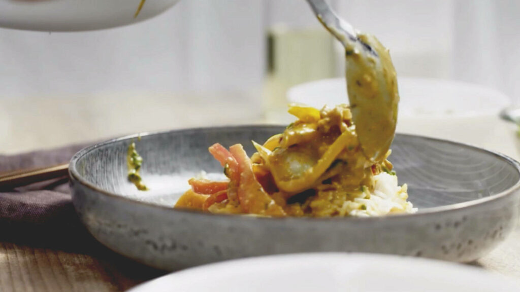 Vibrant Yellow Curry on Rice: Appetizing Wallpaper Background
