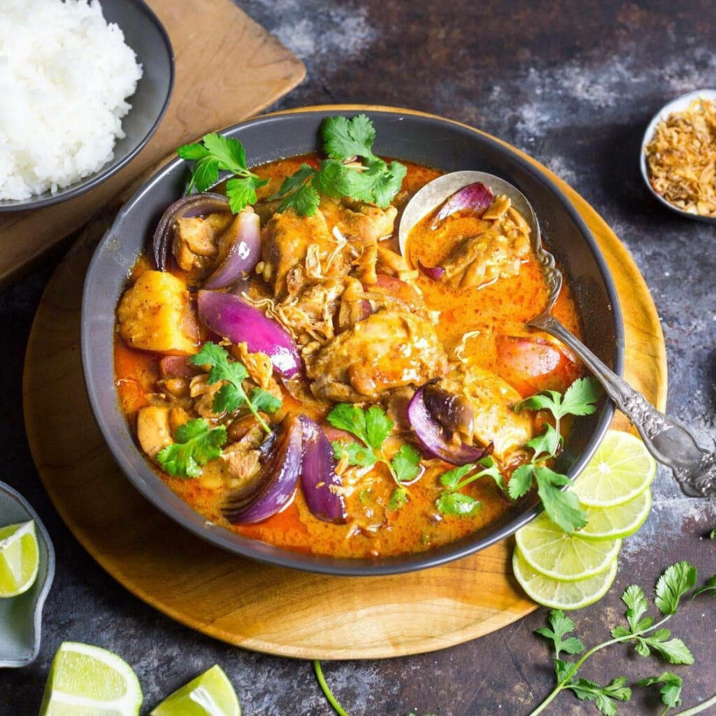 Vibrant Yellow Curry Wallpaper: Aromatic Bowl with Fresh Herbs