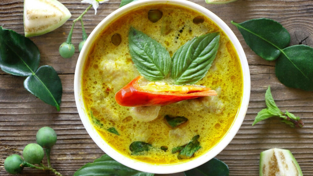 Vibrant Yellow Curry with Basil & Chili | Rustic Wallpaper Background