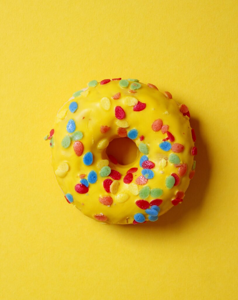 Vibrant Yellow Donut with Sprinkles - Appetizing Dessert Wallpaper