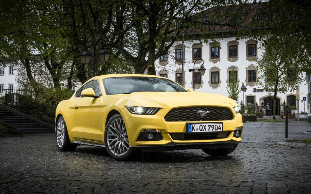 Vibrant Yellow Ford Mustang GT: European Spec on Cobblestone Street Wallpaper