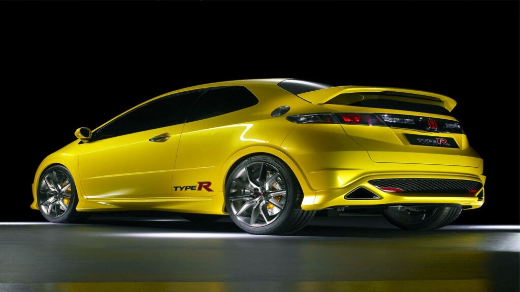 Yellow Honda Civic Type R sports car against dark background showcasing aggressive design Wallpaper