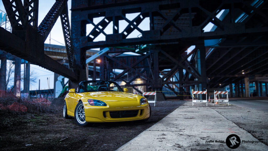 Striking Yellow Honda S2000 in Urban Industrial Background Wallpaper