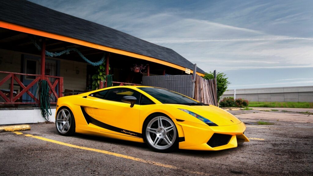 Vibrant Yellow Lamborghini Gallardo LP560: Luxury Meets Rustic Charm Wallpaper