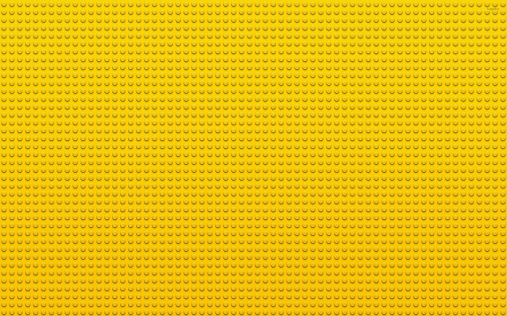 Vibrant yellow Lego-inspired building block wallpaper creating a playful creative background