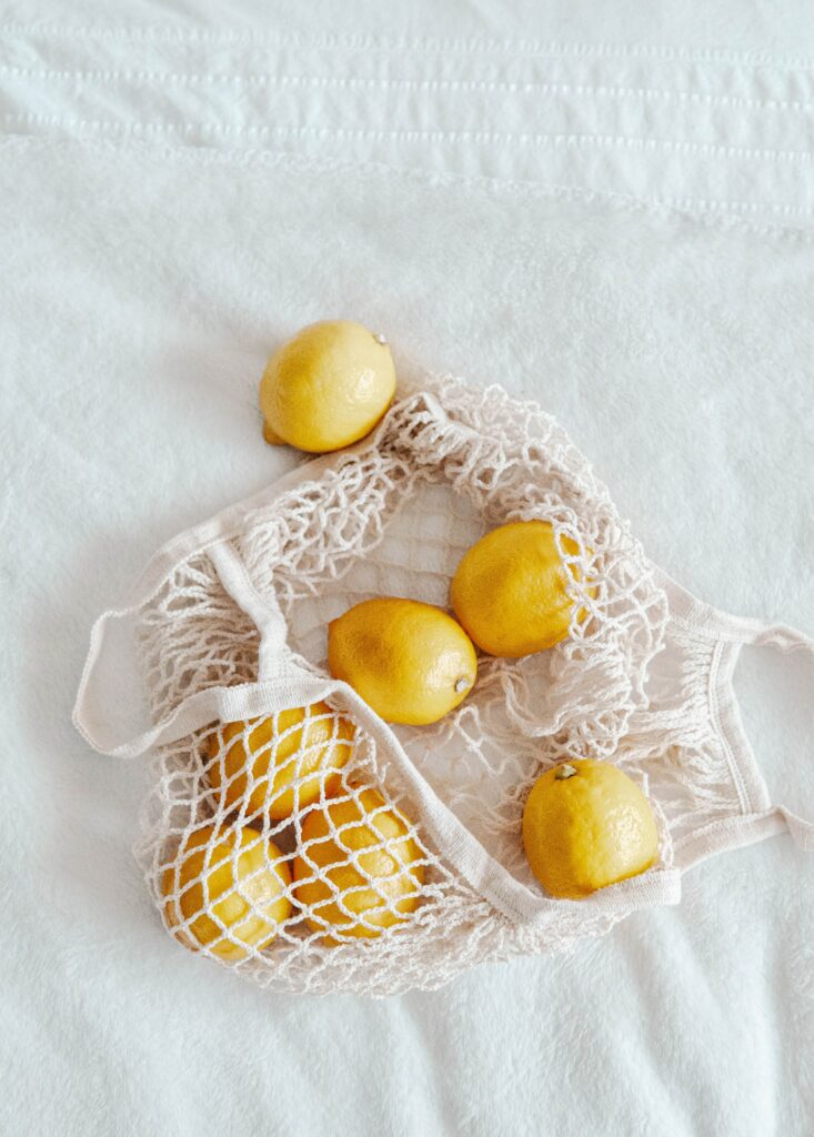 Vibrant Lemon Wallpaper: Fresh Zesty Charm on Textured White Surface