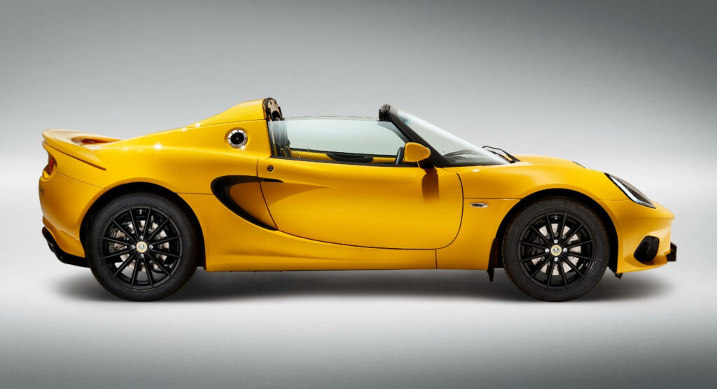 Side view of vibrant yellow Lotus Elise sports car on clean neutral background wallpaper