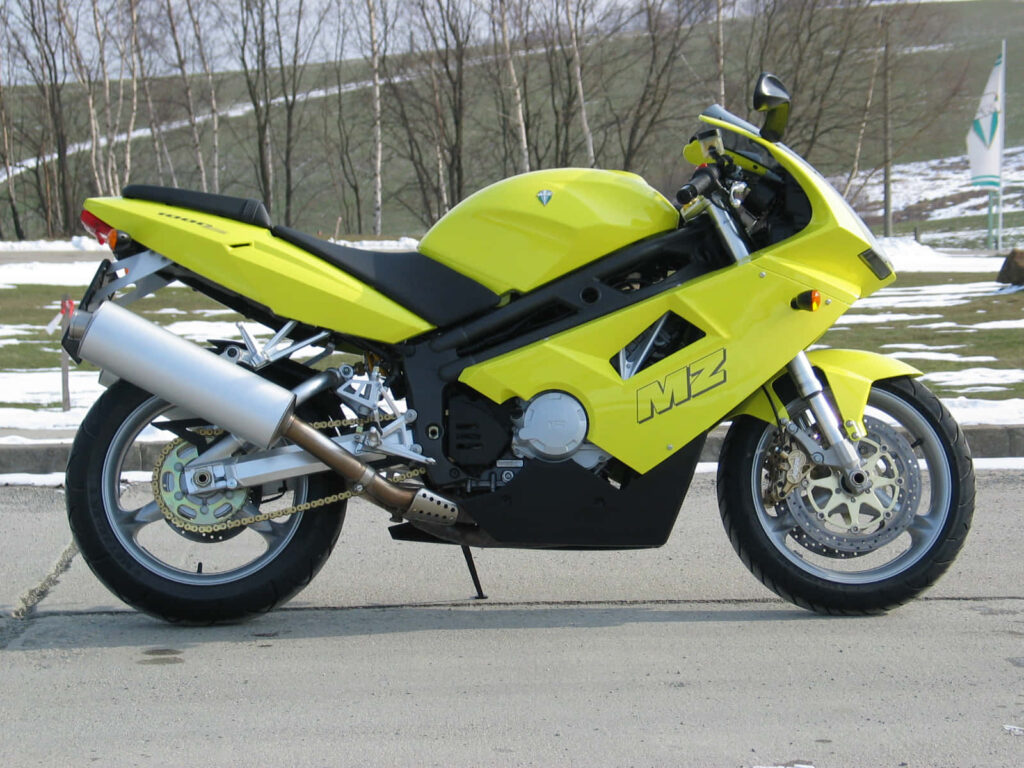 Vibrant Wallpaper: Bright Yellow MZ Motorcycle on a Snowy Road