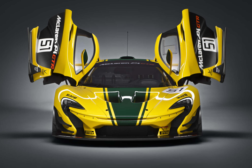 Yellow McLaren P1 GT2 with green stripes and open dihedral doors showcasing aggressive design Wallpaper