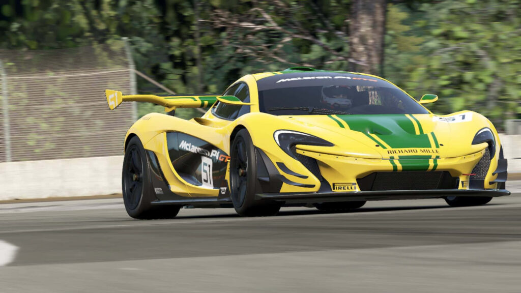 Yellow McLaren P1 GT2 with green racing stripes speeding on racetrack showcasing aerodynamics Wallpaper