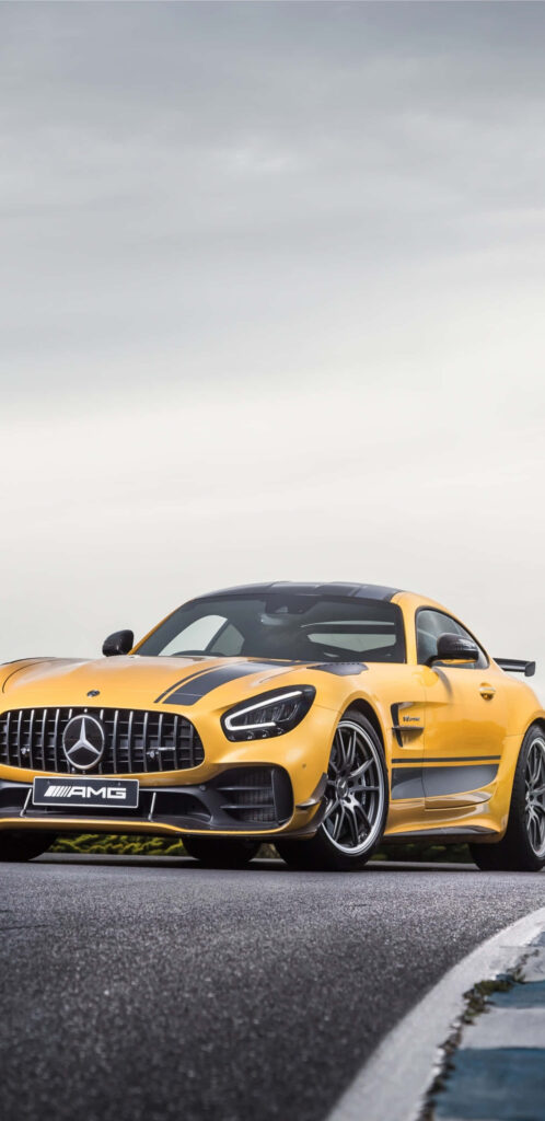Yellow Mercedes AMG GT-R parked on racetrack showcasing power and sporty elegance wallpaper