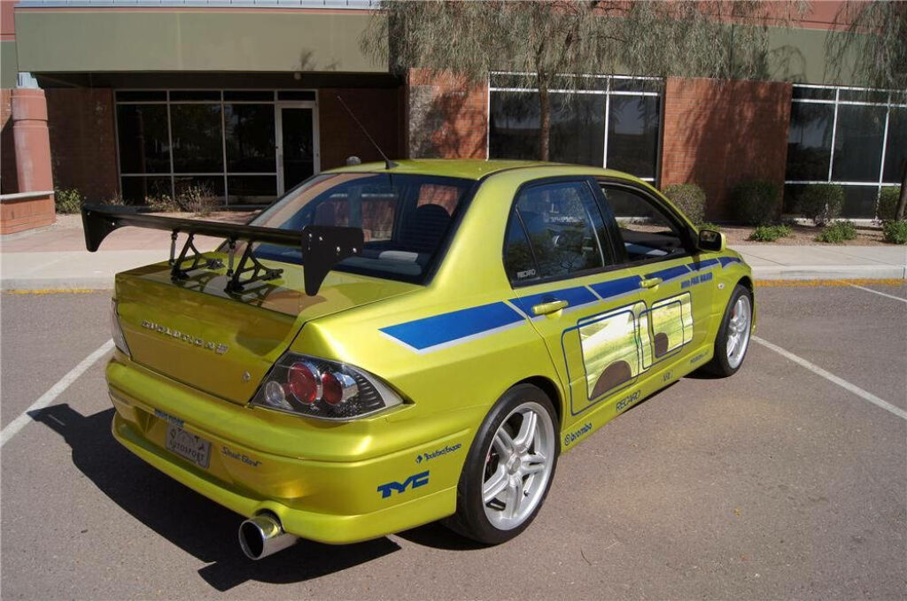 Vibrant Yellow Mitsubishi Lancer Evolution VII Wallpaper Background