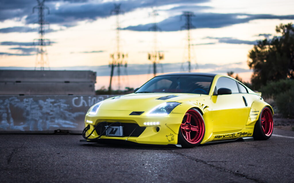 Vibrant Yellow Nissan 350Z with Red Rims Against Dramatic Sky Wallpaper